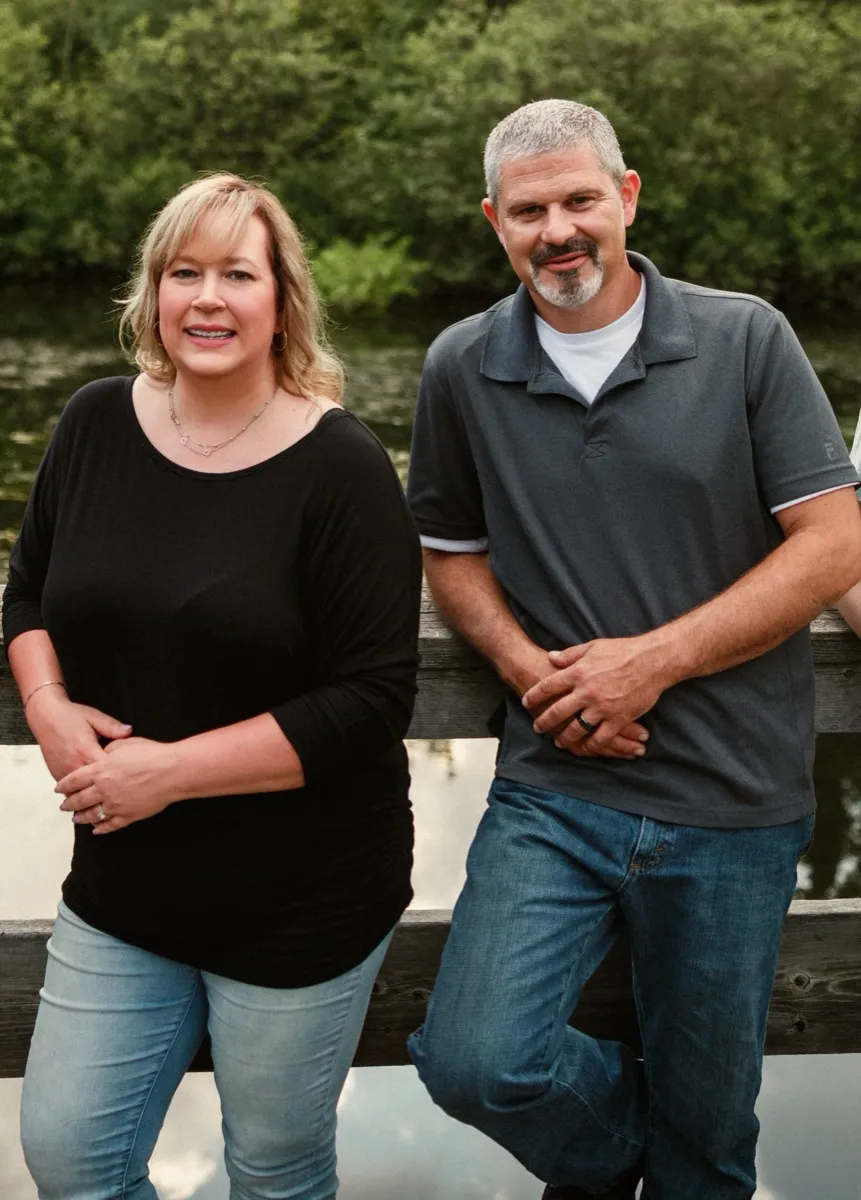 Owners Aaron and Tiffany Schuett standing together by the water