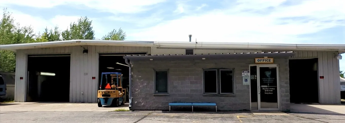 Aaron's Recreation shop building with open garage bays and an office entrance